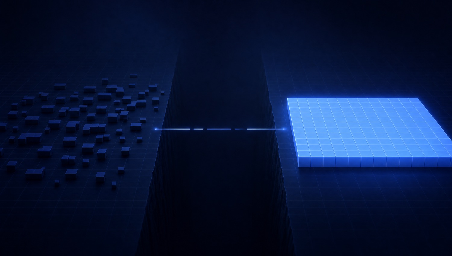 Scattered faint blocks on the left, a solid glowing blue production grid on the right, separated by a dark chasm